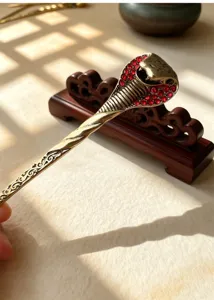 Vintage cobra hair stick featuring sparkling red rhinestones and intricate alloy metal carving.