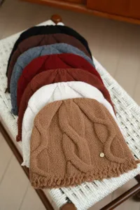 Detailed view of women wool cable knit beanie hat showing winter warmth and texture design.