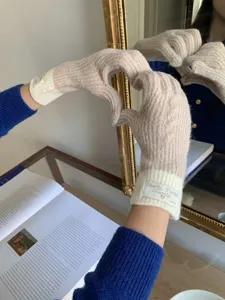 Korean style contrast color knit gloves for women, warm winter touchscreen gloves detail.