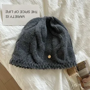 Detail view of dark grey wool knit beanie hat, cozy winter warm cable knit cap for women.
