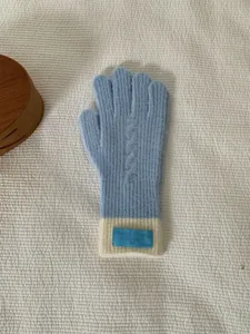 Blue and white knit gloves detail view, soft winter warm touchscreen gloves with cuff label.