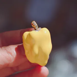 Enamel pepper pendant detail shot, cute yellow fruit charm with sparkling rhinestones.