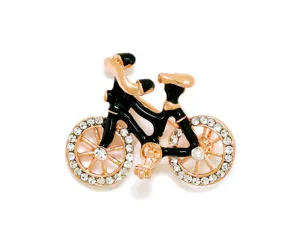 Detail view of the chic bicycle brooch featuring rose gold finish and sparkling rhinestones.