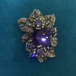 Vintage purple crystal rhinestone brooch detail, antique gold leaf floral lapel pin.