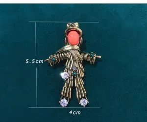 Vintage antique scarecrow brooch with colorful rhinestones and gold alloy. Size: 5.5x4cm.