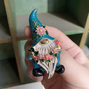 Vintage enamel gnome brooch with colorful flower details for fairy tale character lovers.