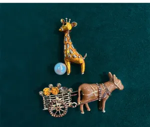 Close-up detail of vintage animal brooches, featuring giraffe and donkey designs with rhinestones.