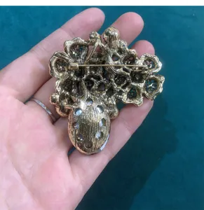 Vintage crystal glass brooch detail showing the back metal pin structure and floral design.