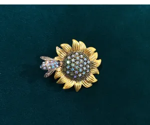 Vintage sunflower and bee brooch detail shot, elegant crystal rhinestone alloy jewelry accent.