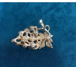 Gold tone grape pearl brooch detail showing secure pin back clasp for sweater or dress.