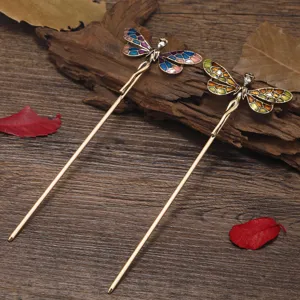 Vintage dragonfly hairpin detail showing exquisite enamel wings, bronze metal stick, and sparkling crystal.