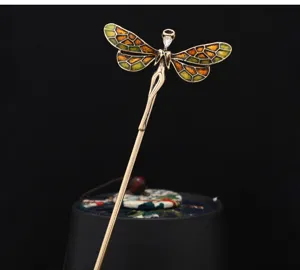 Detailed close-up of the vintage glazed elf hairpin with exquisite enamel wings.