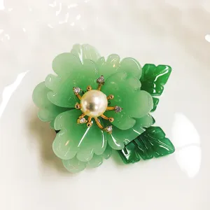 Elegant green flower brooch with freshwater pearl center, vintage costume jewelry pin.