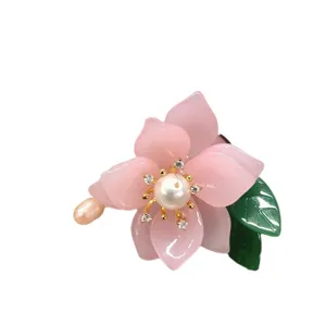 Elegant flower brooch with freshwater pearl and glazed glass petals, vintage pin accessory.