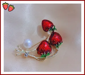 Detailopname van zoete aardbei broche met parels en email, elegant mode-accessoire.