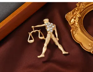 Exquisite gold-plated Libra constellation brooch featuring sparkling rhinestones, elegant detail shot.
