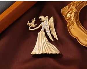Exquisite matte gold angel brooch with sparkling rhinestones, elegant clothing accessory for women.