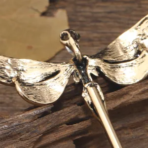 Vintage dragonfly hairpin detail shot showing exquisite metal texture and retro copper stick.