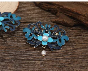 Exquisite Chinese style imitation cloisonne flower hair clip with fresh water pearl tassel detail.