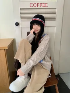 Knitted earflap bomber hat for women, cozy jacquard thermal beanie cap, cold weather headwear.