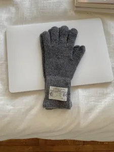 Detailed view of the dark grey knitted wool gloves, showcasing warm rib-knit cuff design.