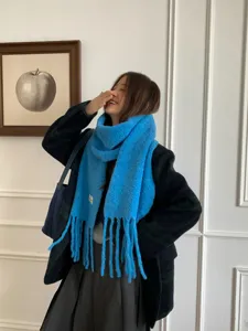 Blue textured winter scarf detail shot, cozy wool blend shawl, lifestyle fashion look