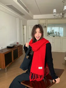 Women's warm winter wool blend scarf with cozy fringe design, soft and stylish apparel accessory.