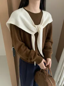 Detailed view of women knit sweater with white cross shawl, elegant Korean wool outerwear top.