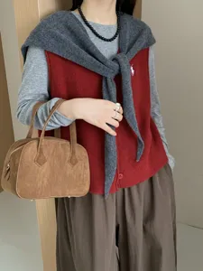 Stylish women's wool knit vest shawl and handbag detail, elegant autumn winter fashion wear.