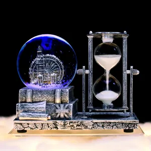 Close-up detail of vintage snow globe hourglass ornament featuring glowing water ball and base.