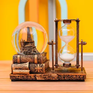 Retro Eiffel Tower snow globe and rotating hourglass desktop ornament with vintage book base decor