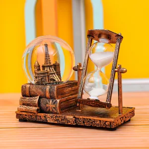 Retro Eiffel Tower snow globe and hourglass desktop decoration for office study room display.