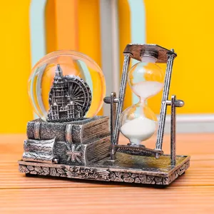 Vintage desktop ornament featuring a snow globe, hourglass, and stacked books design.