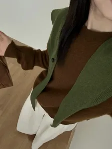 Detail view of women pure wool knit sweater and stylish button cross pointed shawl outerwear.