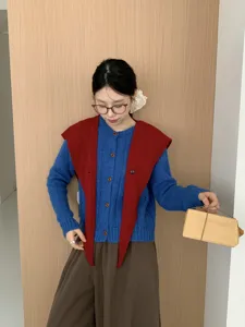 Detail view of Korean style wool button cross sharp corner shawl and blue knit cardigan.