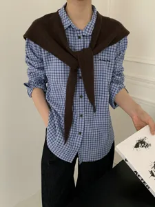Korean style woolen button cross shawl scarf paired with blue plaid shirt for women detail view.