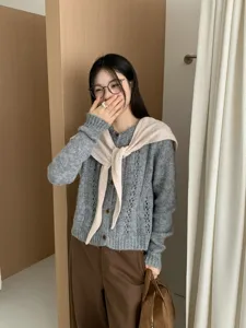 Grey knit cardigan detail view, showing elegant button closure and cozy wool texture for daily.