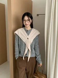 Detailed view of the stylish crisscross buttoned wool shawl scarf, perfect for layering.