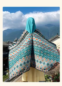 Ethnic colorful geometric hooded shawl cape, warm outdoor travel photography winter outerwear.