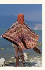 Detailed view of ethnic geometric hooded poncho, showcasing intricate knit texture and outdoor view.