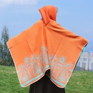 Orange hooded poncho with paisley hem, ethnic style warm travel cape for women fashion outer wear.
