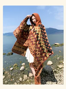 Detailed view of the ethnic geometric hooded poncho, outdoor travel style shawl, cozy knit.