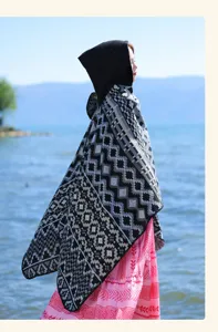 Ethnic style geometric hooded shawl detail, warm winter cape for travel and outdoor photos.