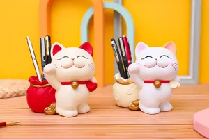 Creative lucky cat pen holder and piggy bank, cute resin desktop organizer for home decor detail.
