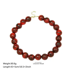 Chunky red marbled acrylic bead necklace with gold clasp, bold statement jewelry for women.