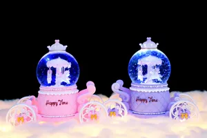 Detailed view of cute carriage unicorn snow globe music box with warm lights and carousel.