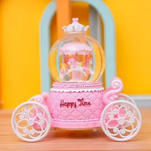 Detail view of the pink carriage crystal ball featuring a cute unicorn carousel design.