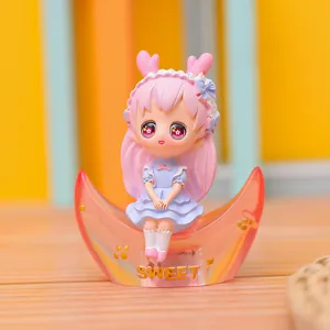 Close-up detail of a cute anime girl figurine sitting on a translucent pink crescent moon base.