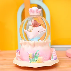 Caja de musica bola de nieve delfin oceano rosa, bonita figura de resina escritorio.