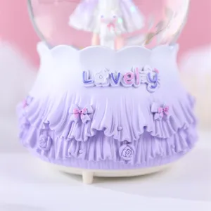 Adorable base de boîte à musique boule à neige violette avec nœuds et volants pour la déco.